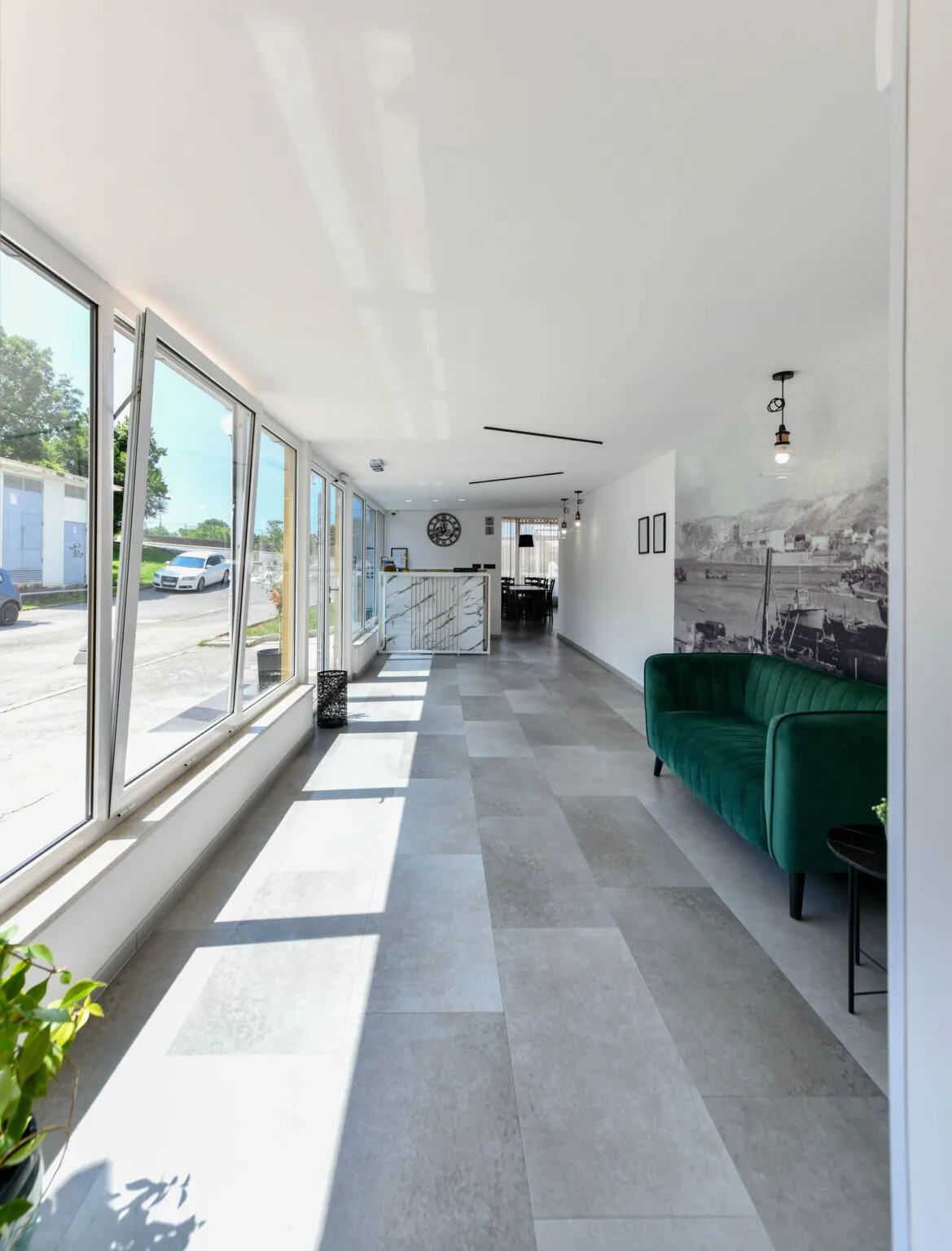 Representative hotel space: A bright hotel lobby with floor-to-ceiling windows and a green seating area.