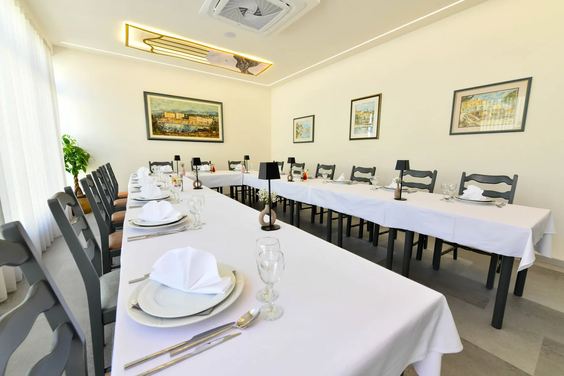 Representative hotel space: A dining room is arranged with long tables set for a meal.