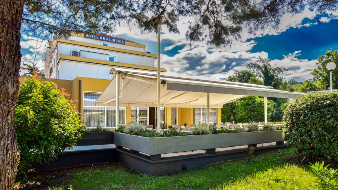 Representative hotel space: The hotel exterior has a white canopy over an outdoor seating area.