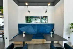 Representative hotel space: A dining area features a long table in front of a blue wall.