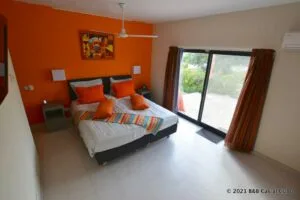 Representative hotel space: A bedroom with a bed beside a large sliding glass door.
