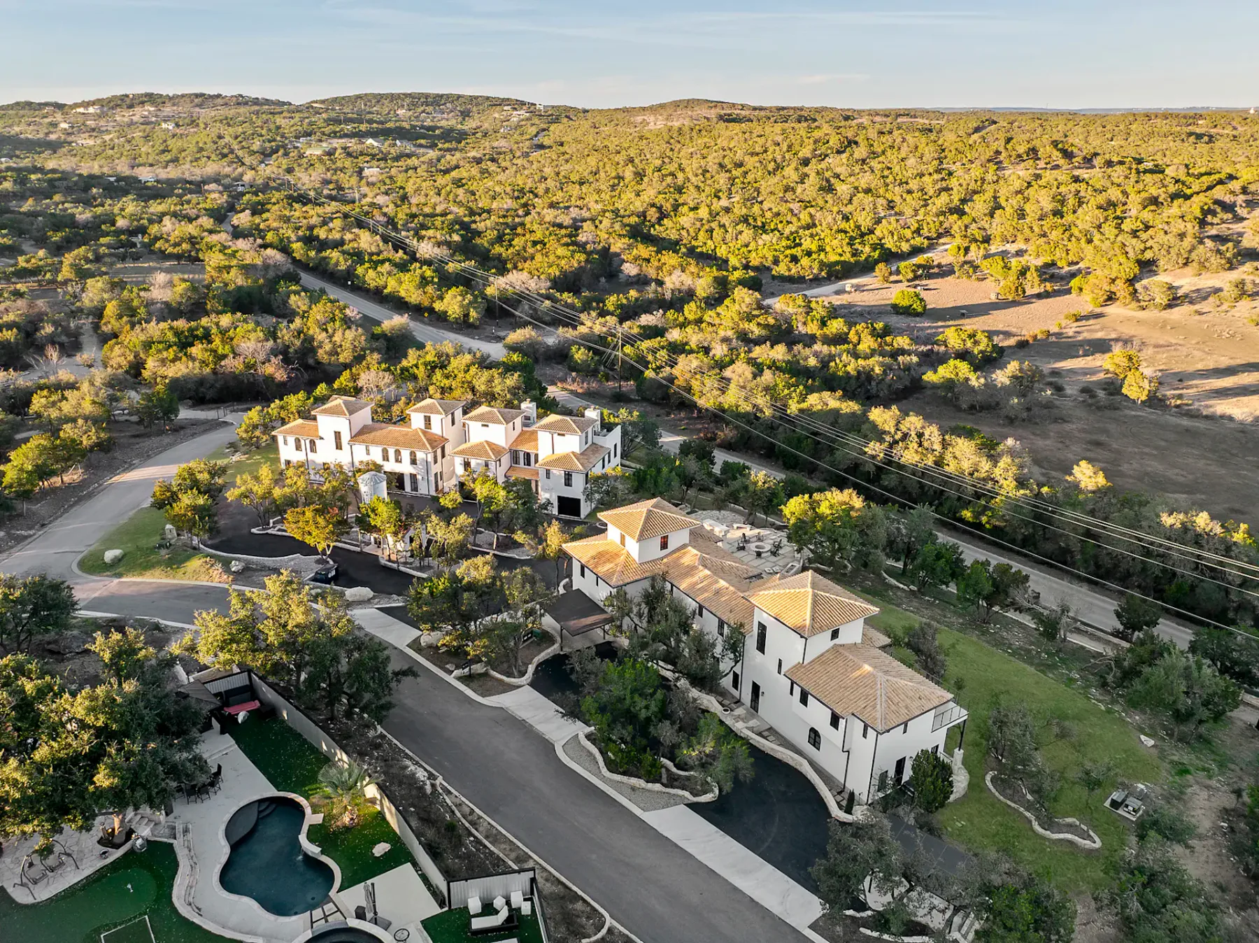 Shared amenity: An aerial view shows a cluster of buildings surrounded by wooded hills.