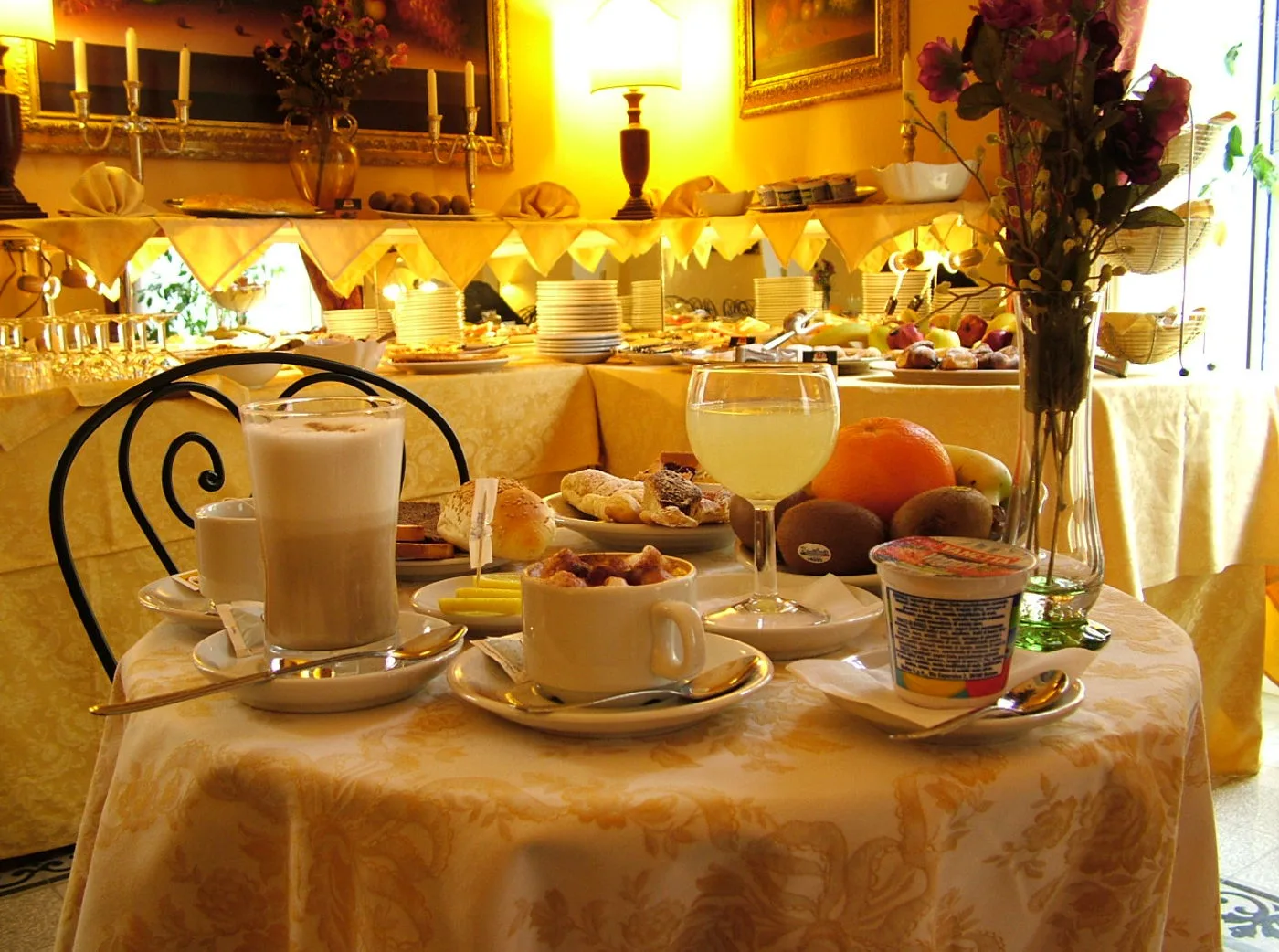 Representative hotel space: A breakfast buffet displays pastries, fruit, and drinks on a decorated table.