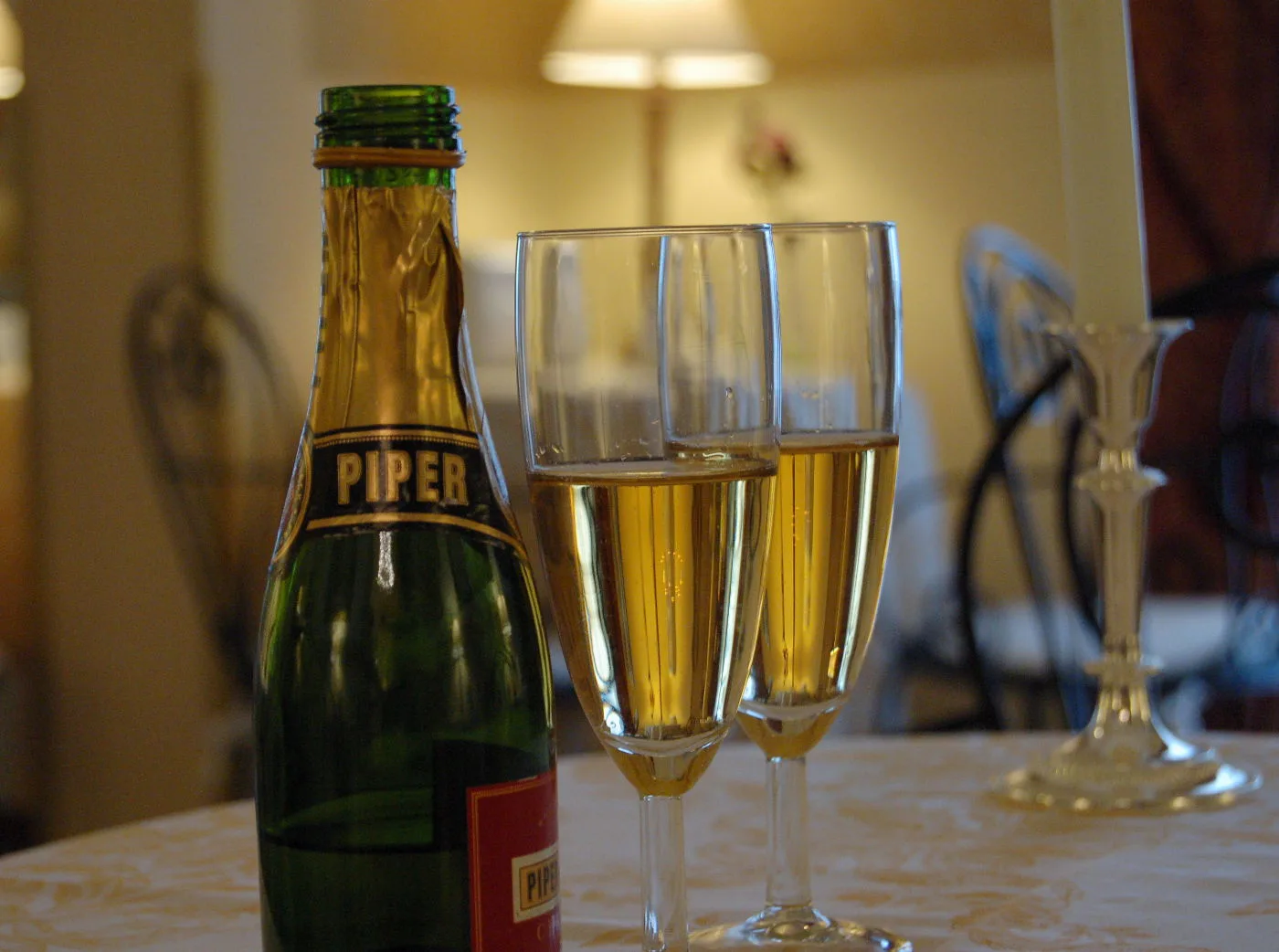 Representative hotel space: A bottle and two glasses of sparkling wine sit on a table in a dining room.