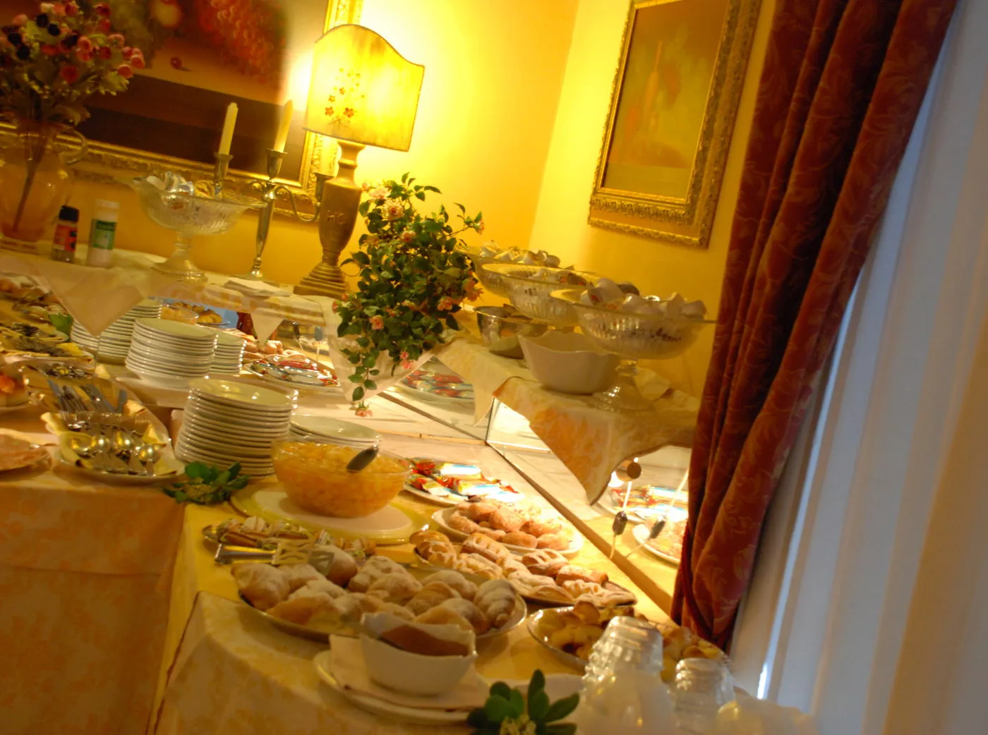 Representative hotel space: A buffet table displays plates, serving dishes, and an assortment of food.