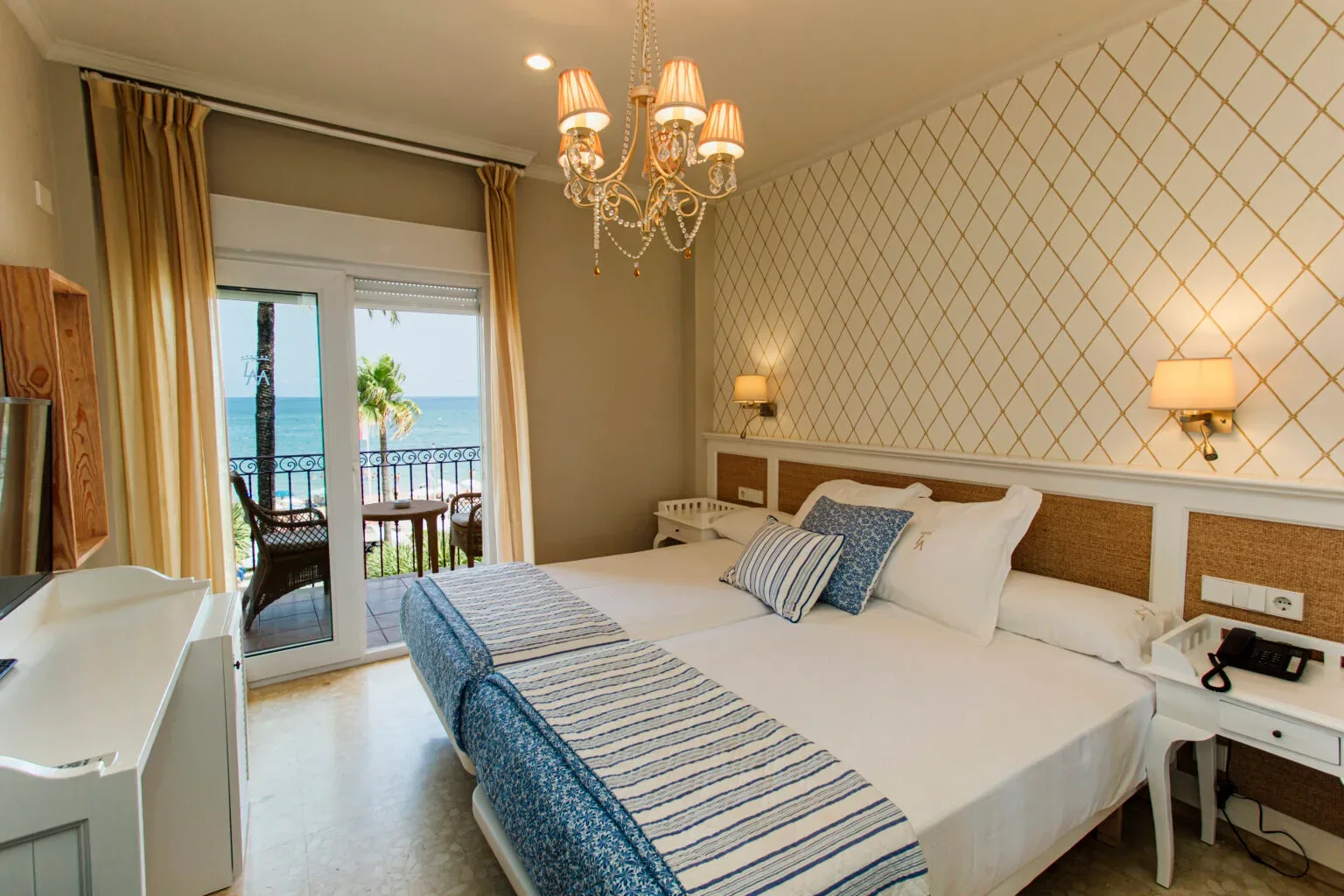 Representative hotel space: A bedroom with a bed and glass doors opening onto a balcony.