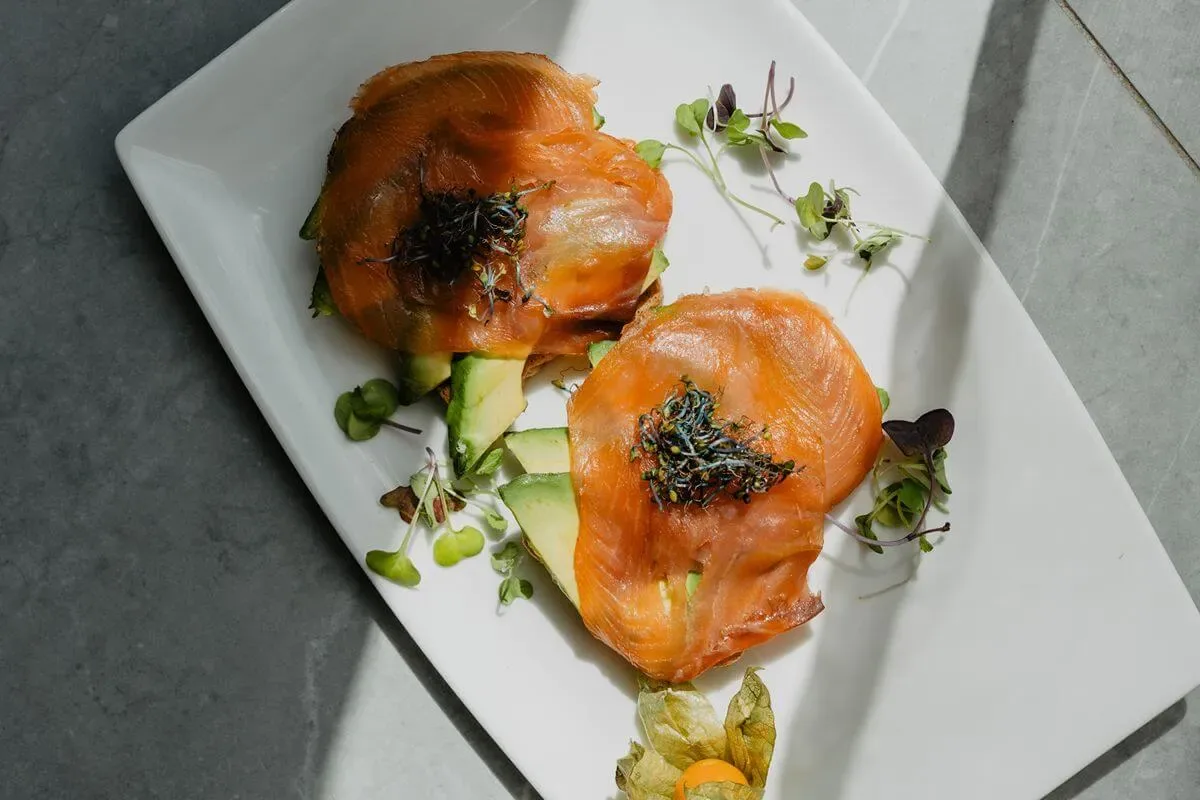Representative hotel space: A plated dish of salmon with greens and garnish.