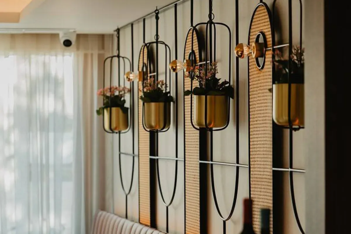 Representative hotel space: Decorative hanging planters line a wall beside a curtained window.
