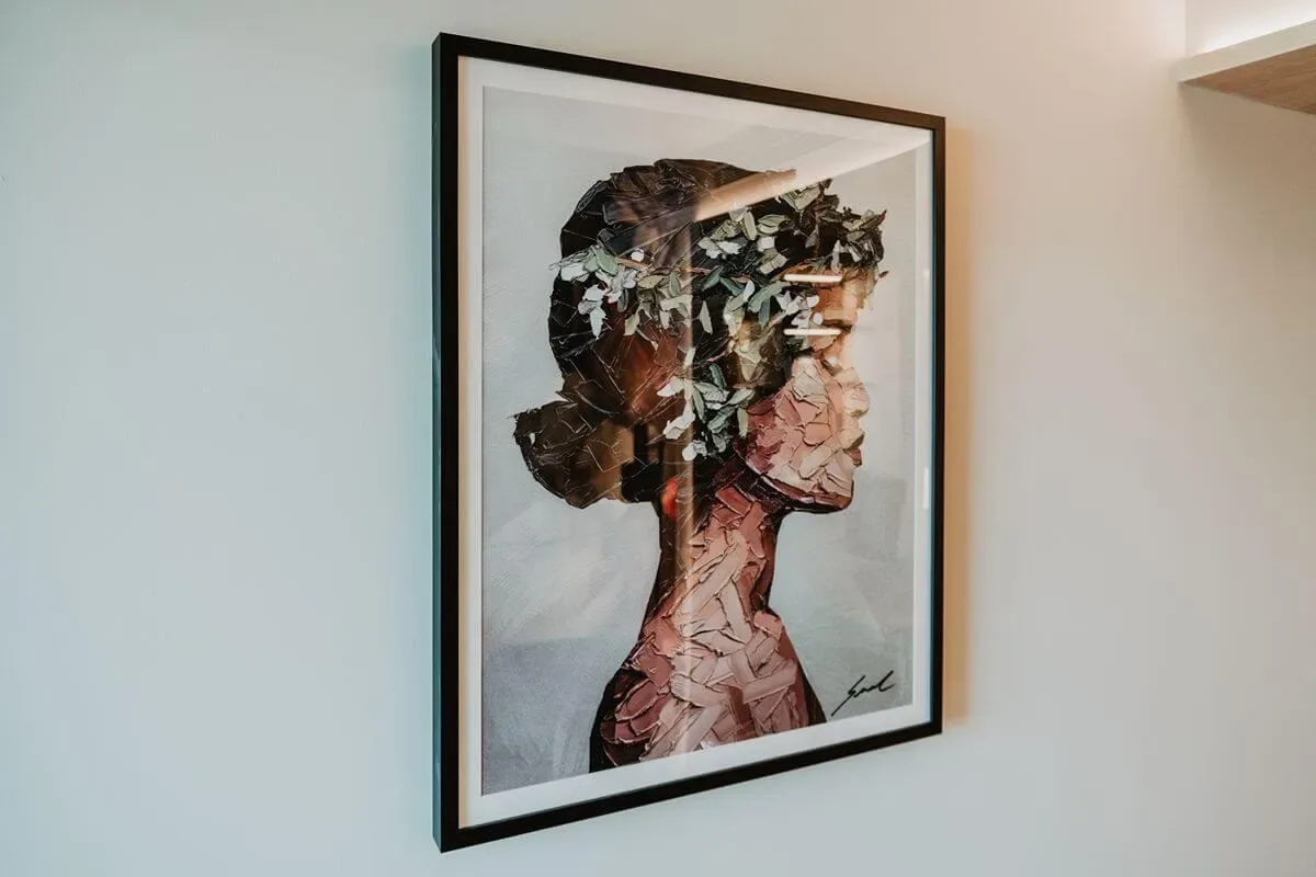 Representative hotel space: Framed portrait artwork hangs on a light-colored wall.