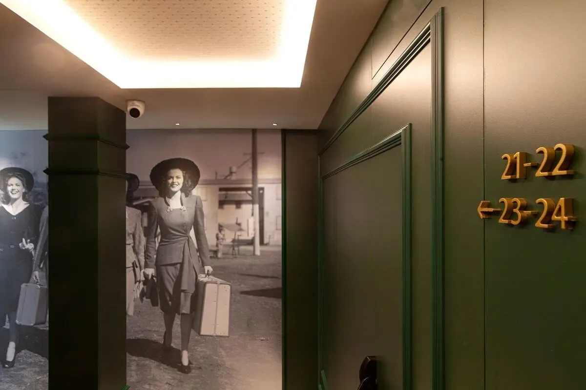 Representative hotel space: A hotel hallway displays a large black-and-white photograph beside room number signs.