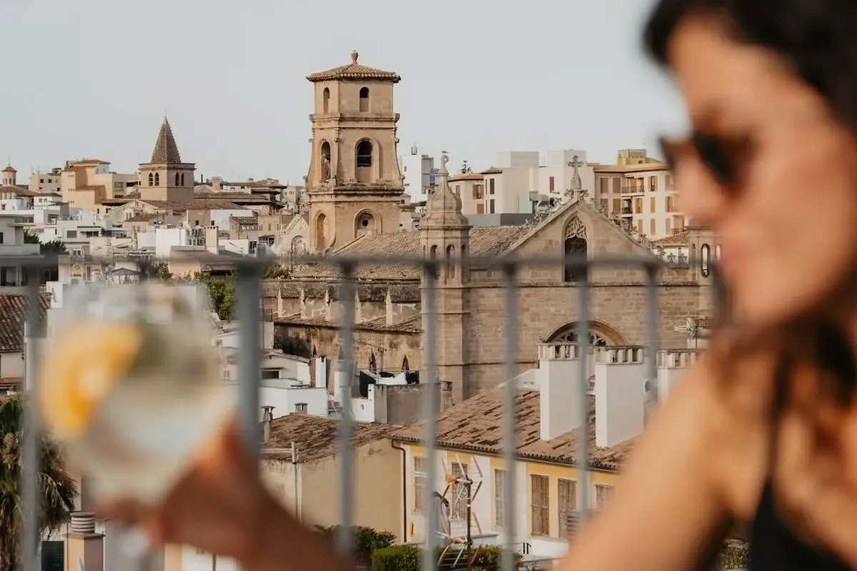 Representative hotel space: A cityscape with historic buildings and a bell tower, viewed from a terrace.