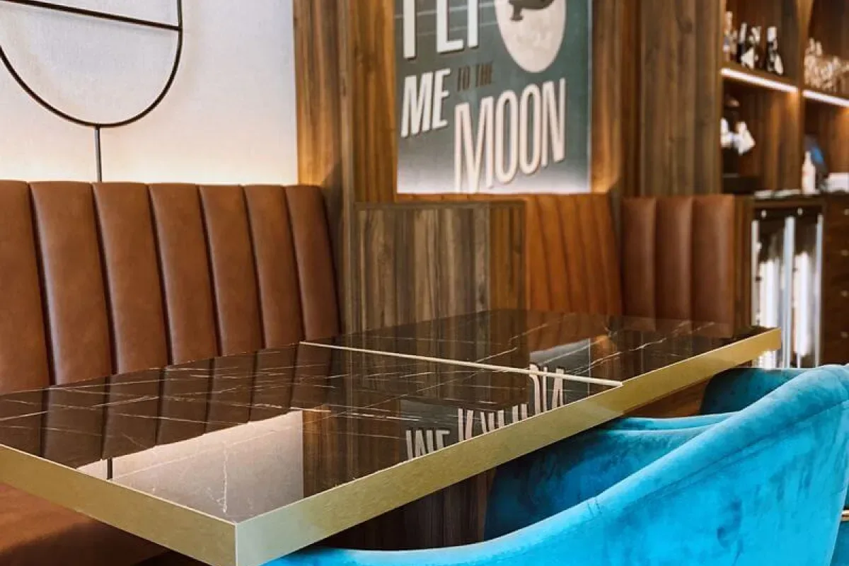 Representative hotel space: Restaurant dining area with a glossy table and upholstered seating.