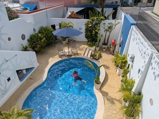 Representative hotel space: An outdoor pool courtyard with surrounding seating and potted plants.