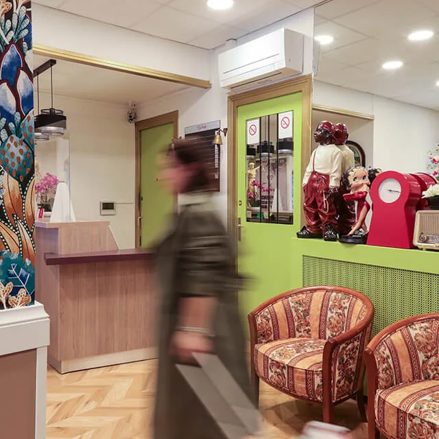 Representative hotel space: A reception area with a wooden counter and patterned seating.