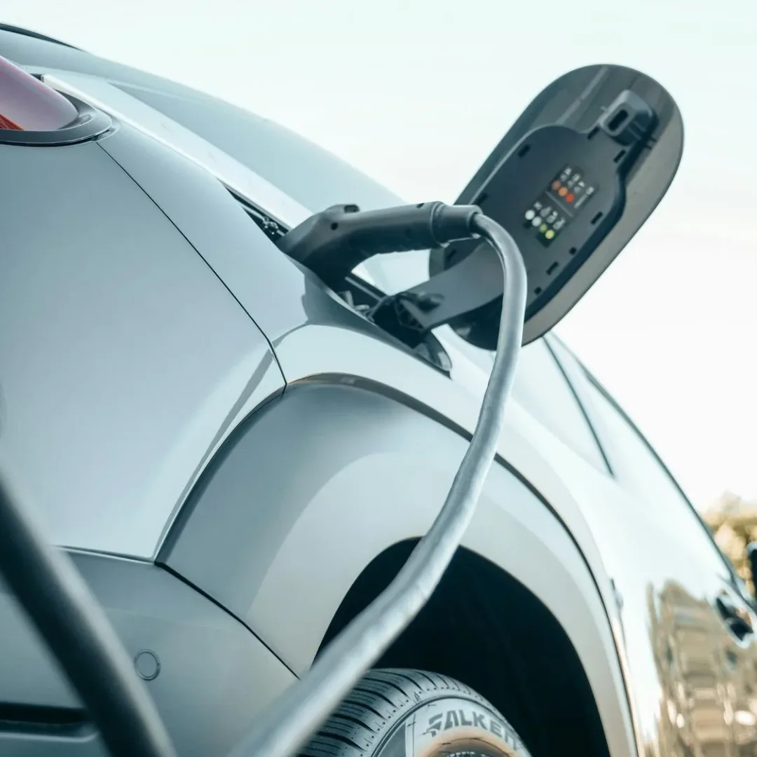 Representative hotel space: A white electric car is connected to a charging cable.
