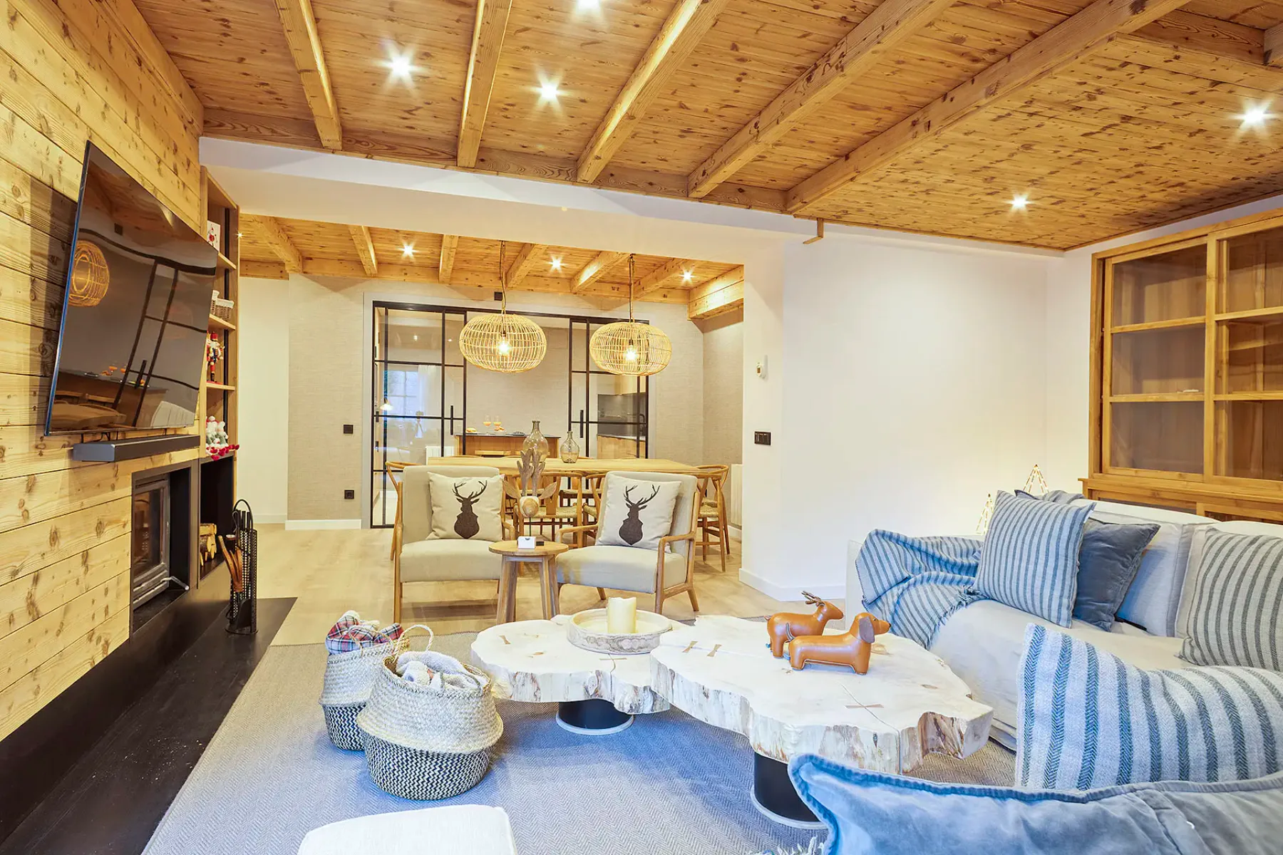 A bright living room with a striped sofa and a dining area beyond.