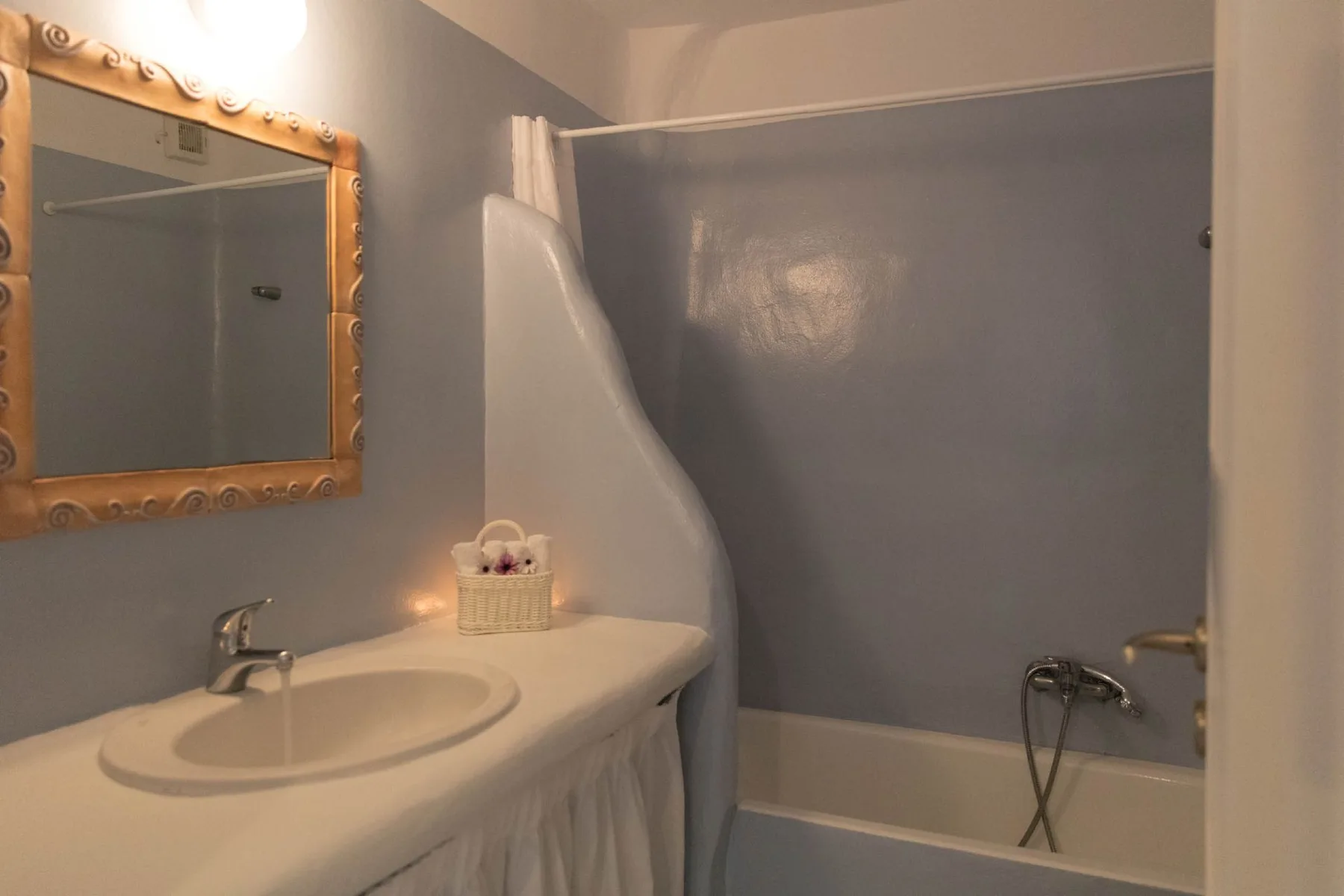 A bathroom vanity with a sink sits beside a bathtub and shower.