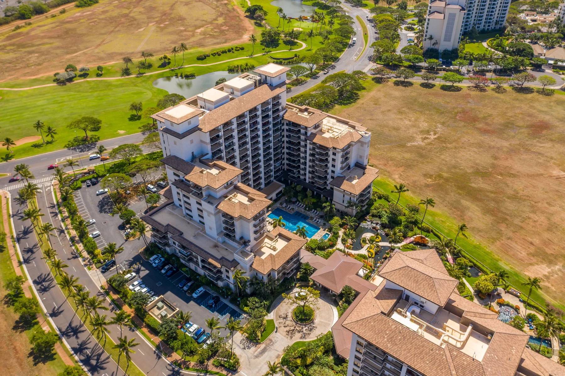 Shared amenity: Aerial view of a high-rise building surrounded by lawns and roads.