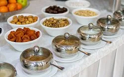 Representative hotel space: A buffet table displays bowls of food and serving dishes.