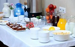 Representative hotel space: A buffet table displays pastries, fruit, drinks, and serving bowls.