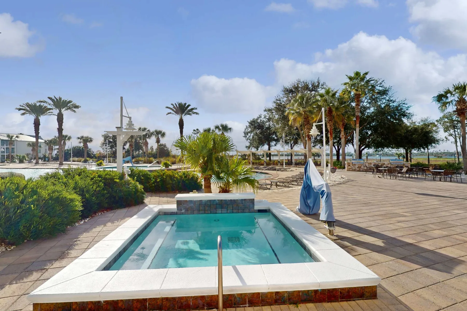 Shared amenity: An outdoor pool sits in a paved courtyard surrounded by palm trees.
