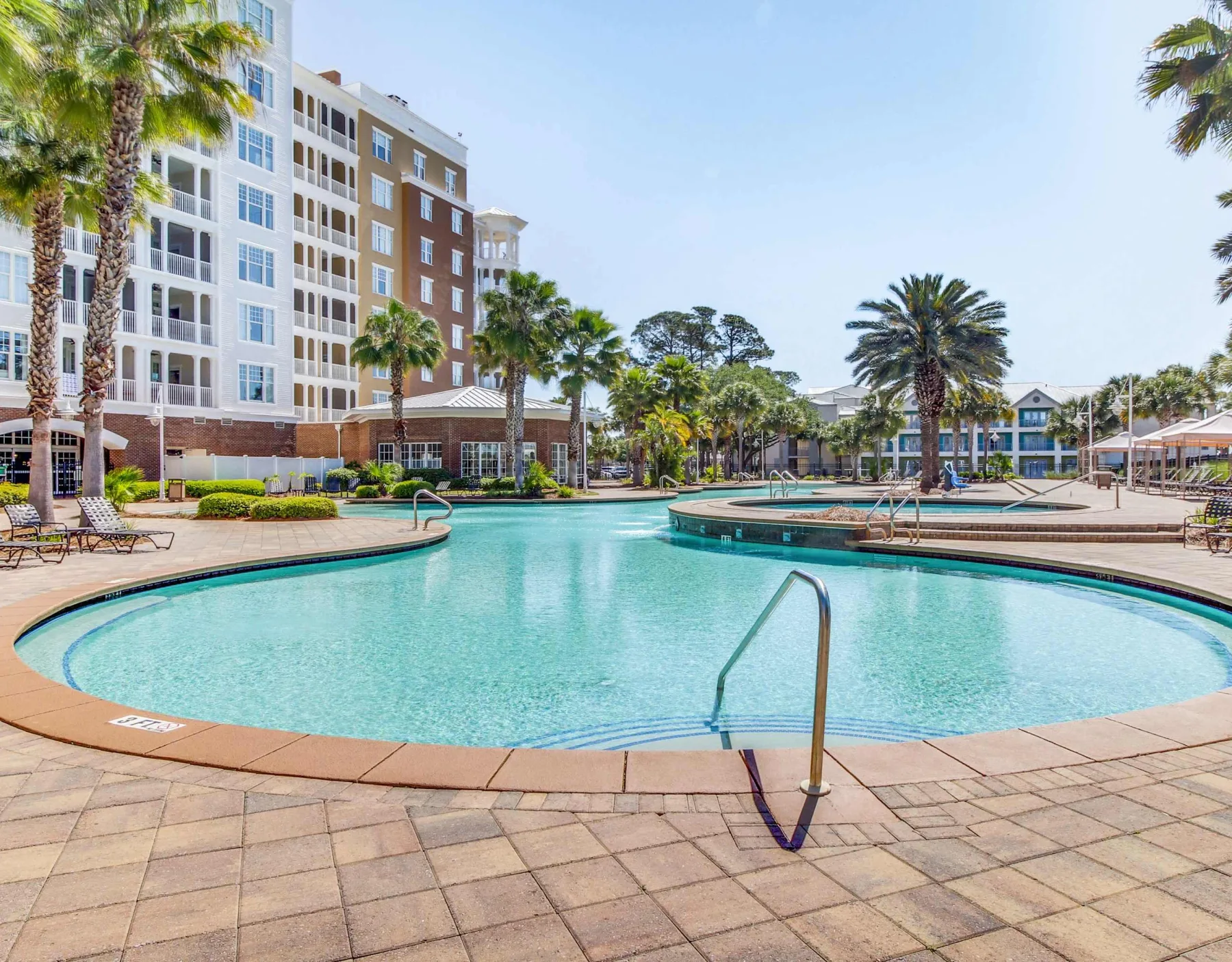 Shared amenity: A swimming pool sits beside a landscaped courtyard and multi-story buildings.