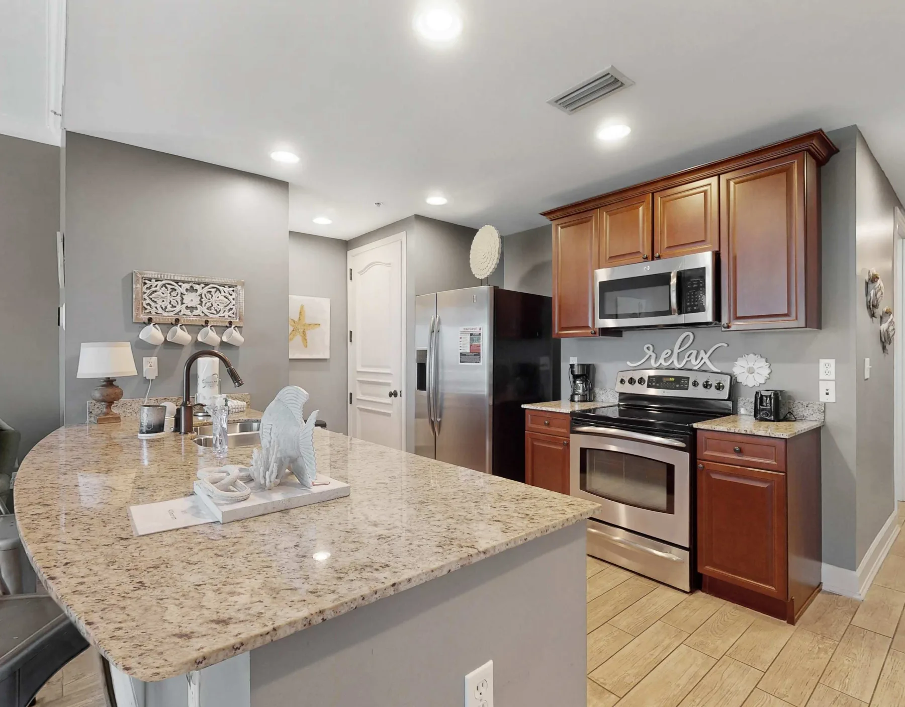 A kitchen with a large island and wood cabinetry.
