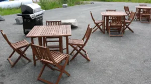 Representative hotel space: An outdoor patio with wooden tables and chairs on a paved surface.