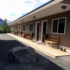 Representative hotel space: A row of exterior doors and windows faces a paved walkway.