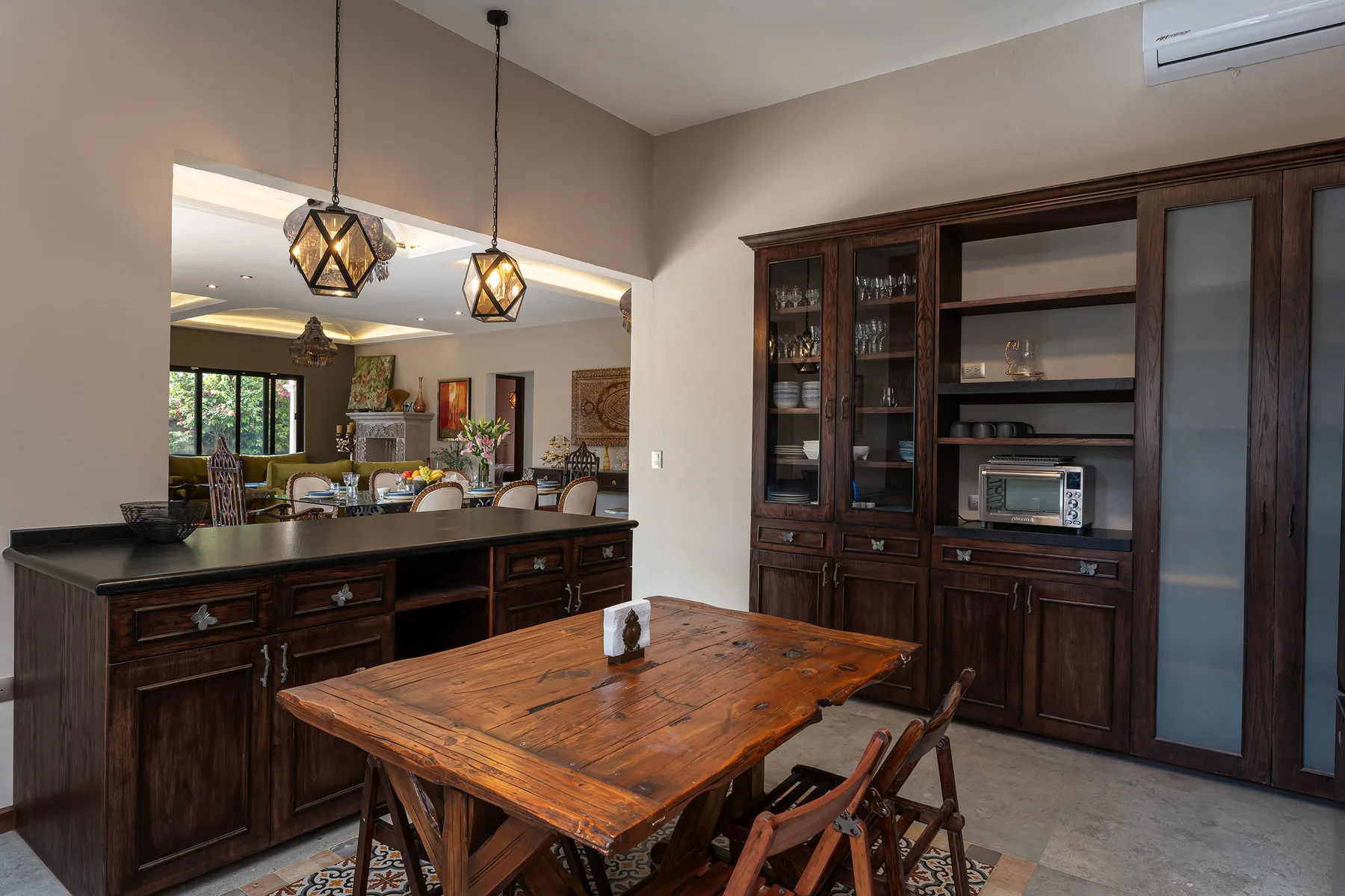 A dining area with a wooden table and dark built-in cabinetry.