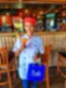 Representative hotel space: A blurred indoor counter scene with wooden seating in the foreground.
