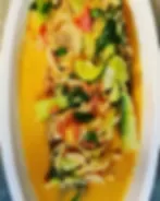 Representative hotel space: A plated dish with greens and colorful ingredients sits on a white oval plate.