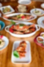 Representative hotel space: A dining table displays several prepared dishes and plated food.