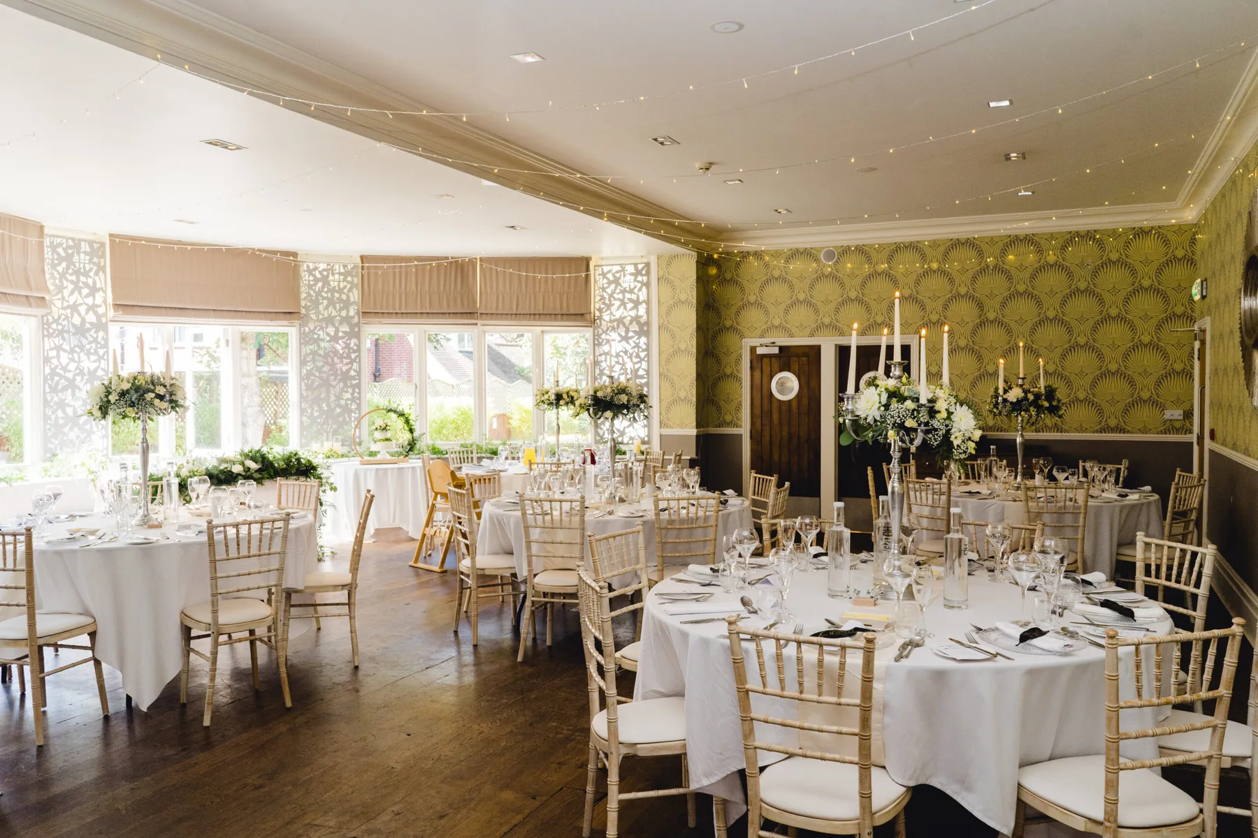 Representative hotel space: A banquet dining room with round tables set for a meal.