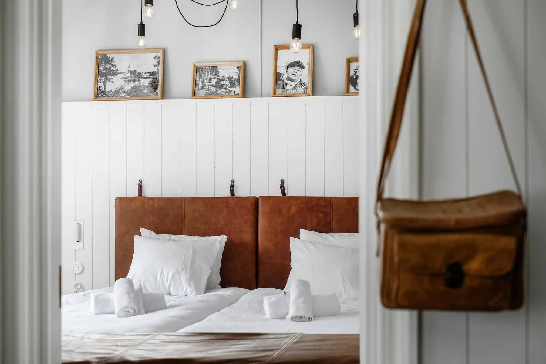 Espacio representativo del hotel: Un dormitorio con dos camas y cuadros enmarcados sobre los cabeceros.