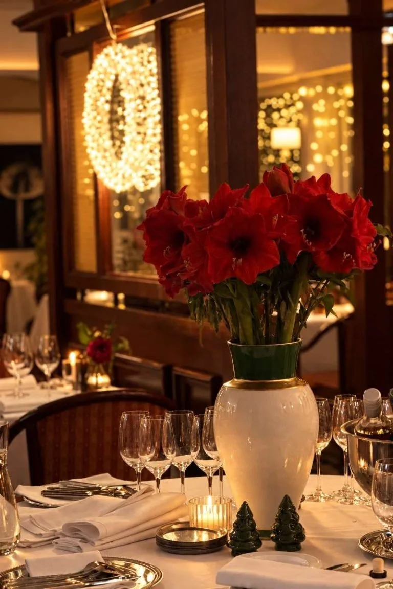 Representative hotel space: A warmly lit dining table features red flowers and neatly arranged glassware.