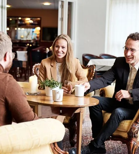 Representative hotel space: People sit around a table in a hotel lounge.