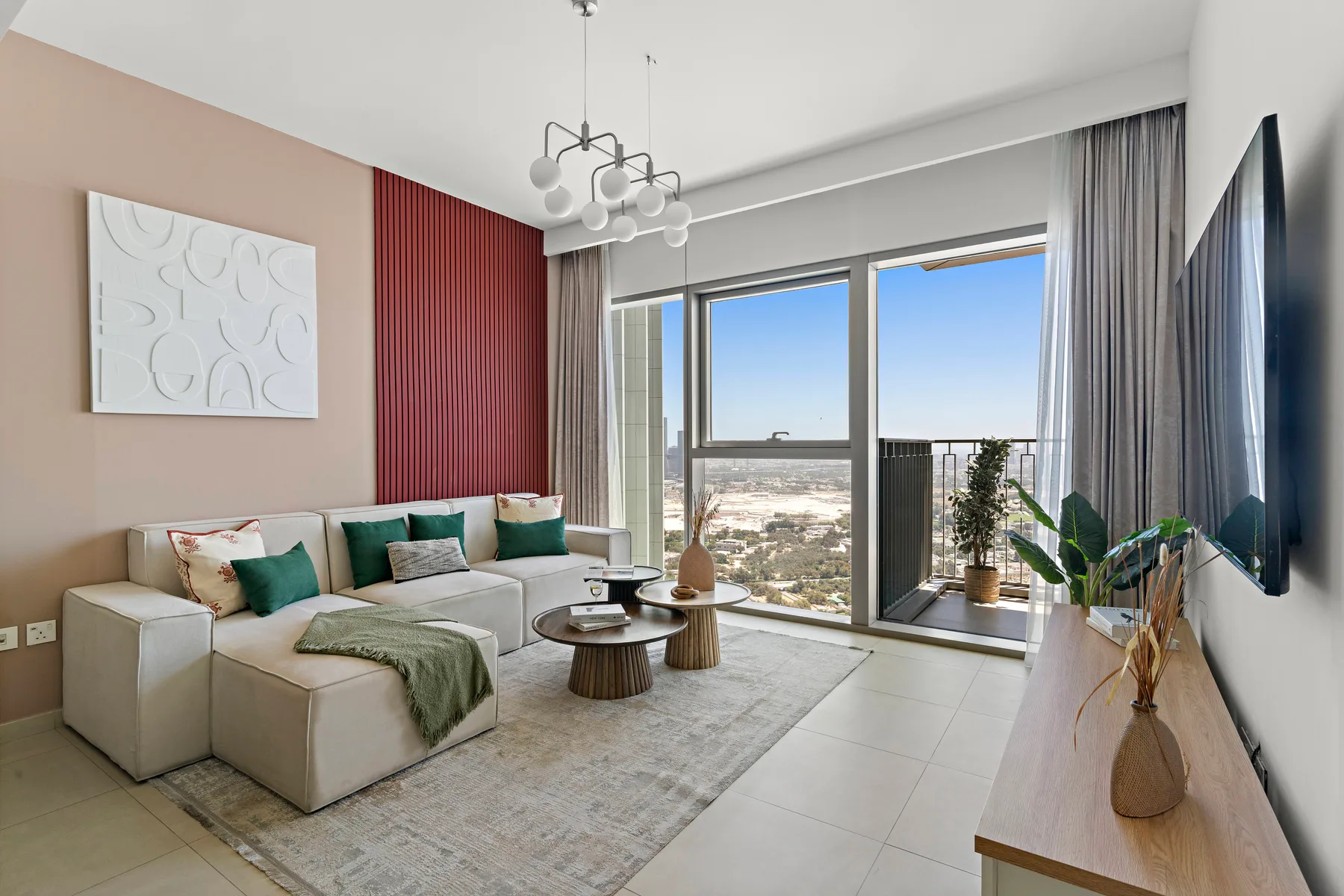 A living room with seating, a coffee table, and large windows.