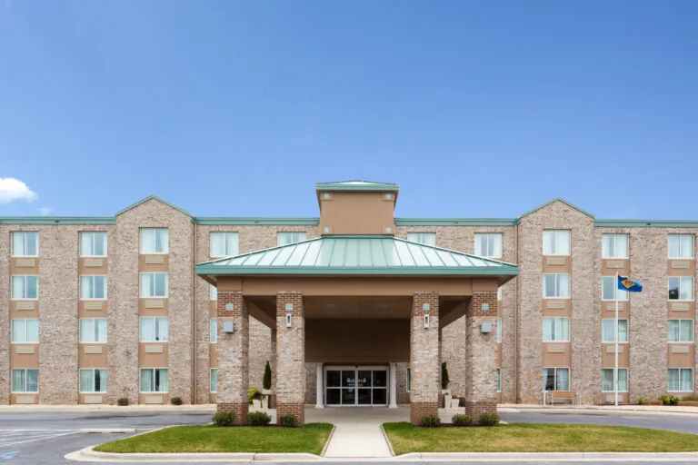 Representative hotel space: A multi-story hotel building with a covered entrance and landscaped grounds.