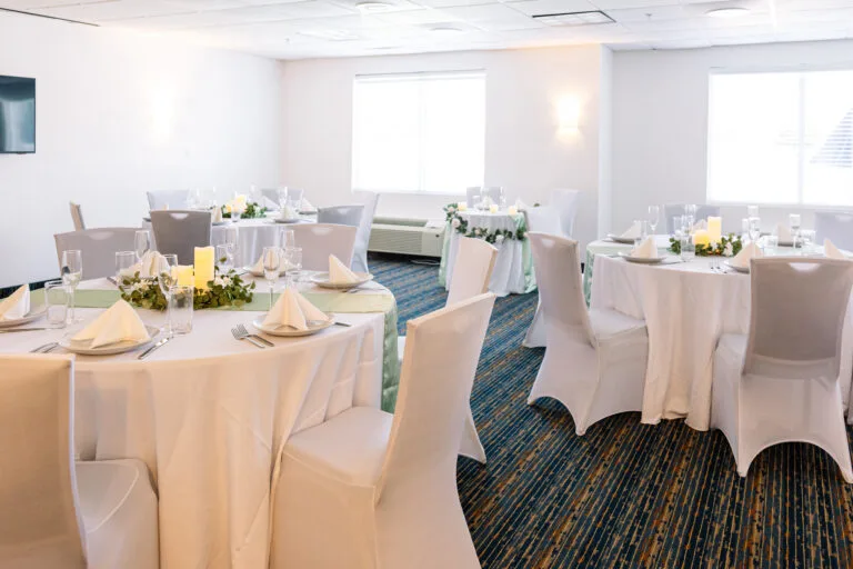 Representative hotel space: A banquet room with round tables set for dining.