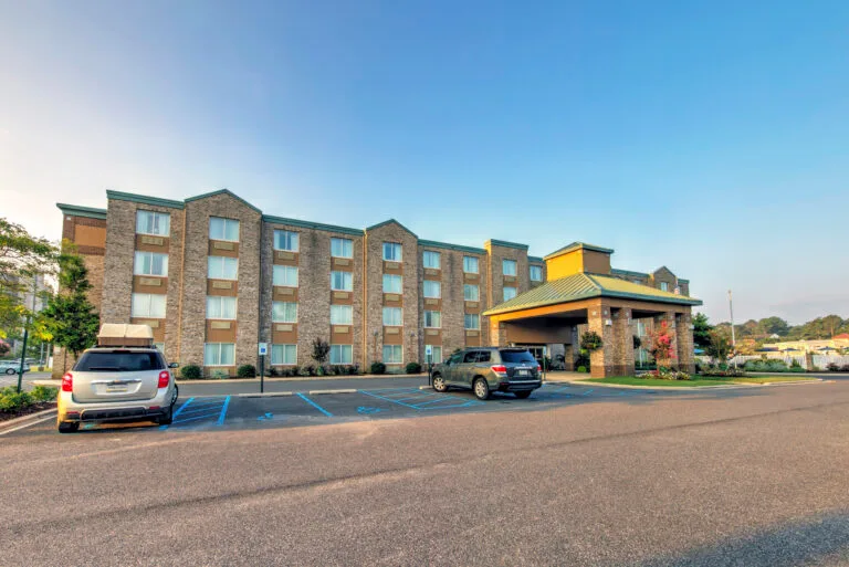 Representative hotel space: A multi-story hotel building with a covered entrance and parking lot.