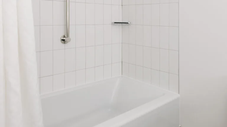 Representative hotel space: A tiled bathroom with a bathtub and shower fixture.