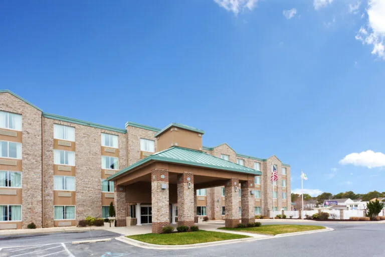 Representative hotel space: Hotel entrance with a covered driveway beneath a blue sky.