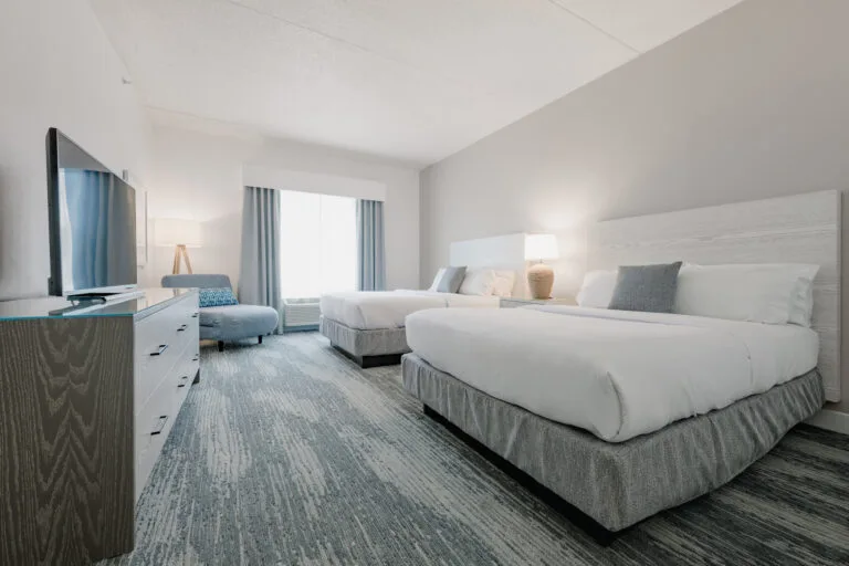 Representative hotel space: A bright hotel bedroom with two beds and a television.