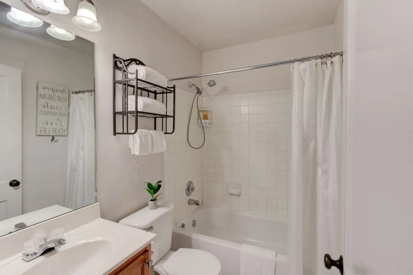 A bathroom with a bathtub, shower, and sink.