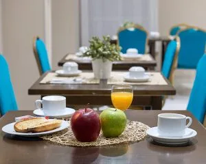 Representative hotel space: A dining area with a set table, fruit, and breakfast dishes.