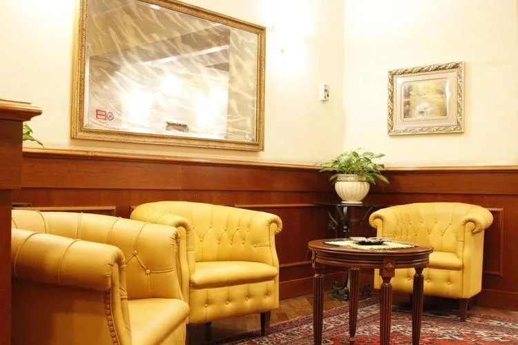 Representative hotel space: A lounge with yellow seating and a small table.