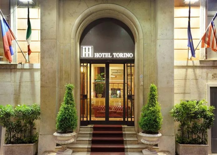 Representative hotel space: Hotel entrance with an arched doorway and potted greenery.