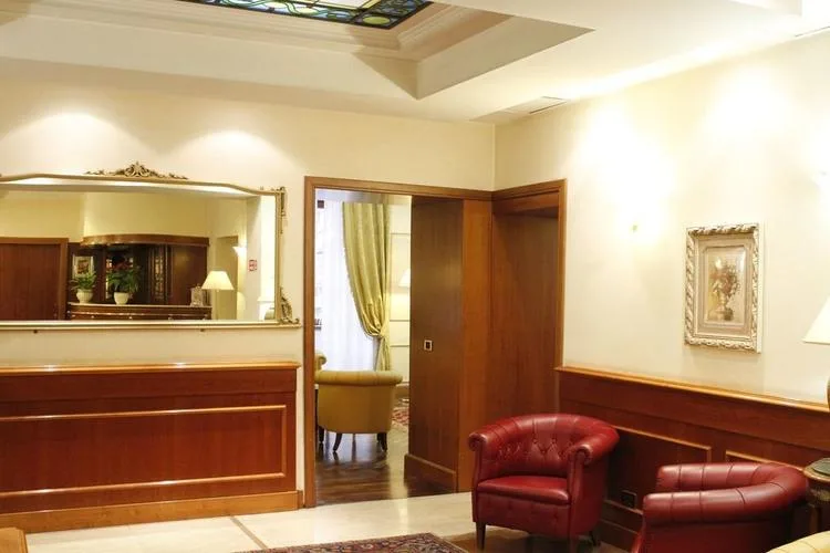 Representative hotel space: A warmly lit hotel lounge has wood paneling, a large mirror, and leather seating.