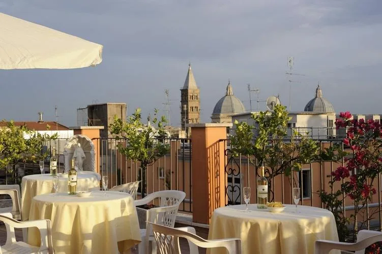 Representative hotel space: A rooftop dining terrace has round tables set beneath a pale umbrella.